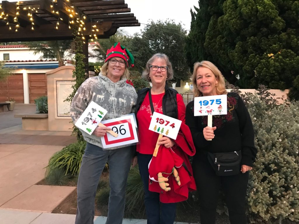 Robynn, Maureen and Lori, holding class signs