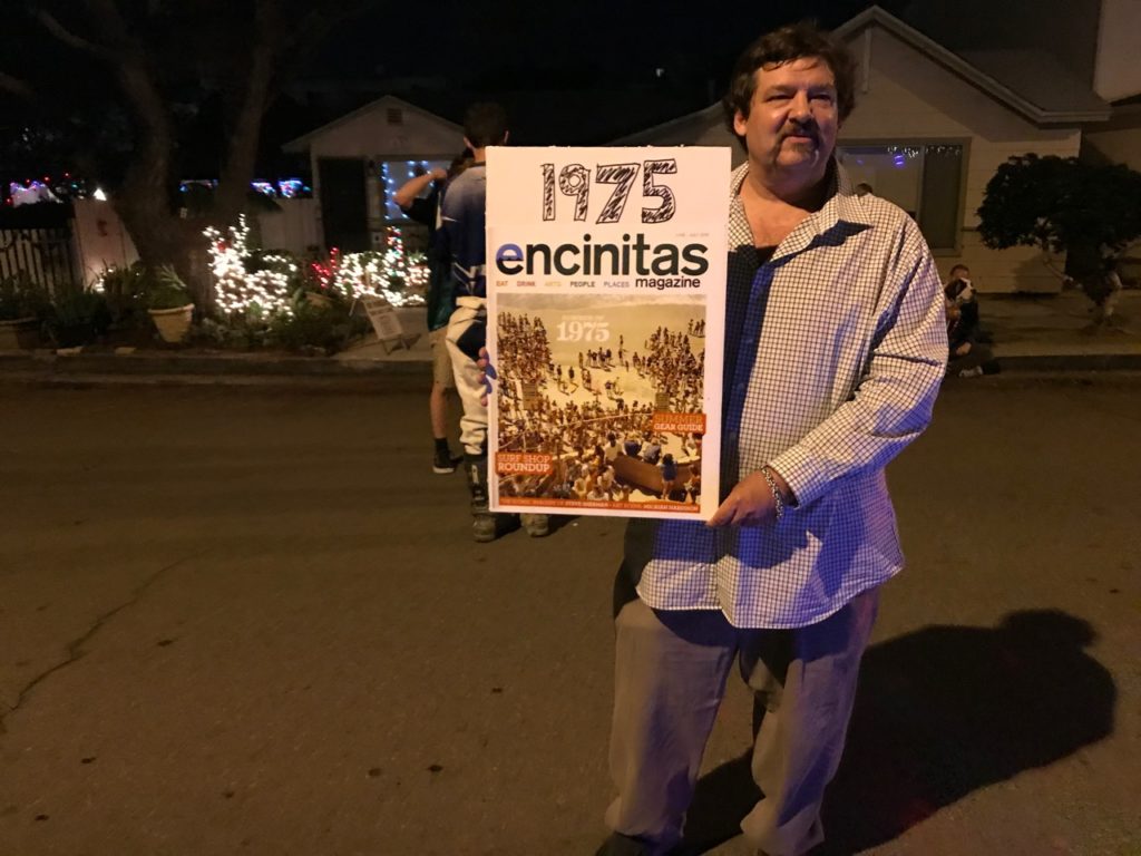 Kyle, holding poster with his photo and 1975