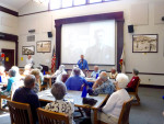Principal Page in front of members of classes of 1940-1950