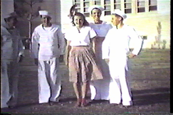 Four Sailors and a girl in front of the school