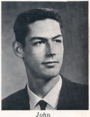 Headshot of John in suit and tie