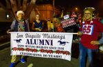 Parade banner held by alumni with